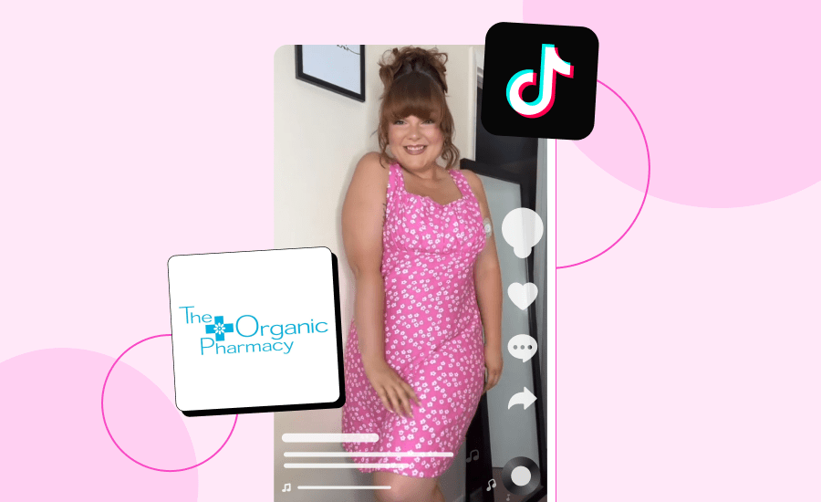 Woman poses and smiles at the camera in a pink dress.